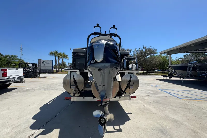 Slide: The Image of 2023 Veranda VTX 25RC pontoon boat on trailer in sunny outdoor setting. - 14