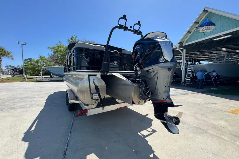 Slide: The Image of 2023 Veranda VTX 25RC pontoon boat with powerful outboard motor on a trailer. - 15