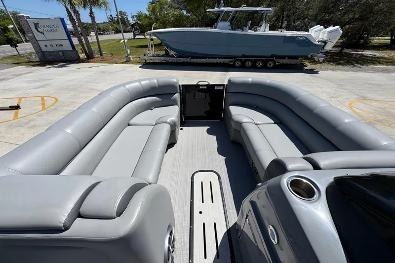 Slide: The Image of 2023 Veranda VTX 25RC pontoon boat with spacious gray seating and modern design. - 18
