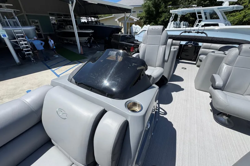 Slide: The Image of 2023 Veranda VTX 25RC pontoon boat interior with gray seating and helm. - 23