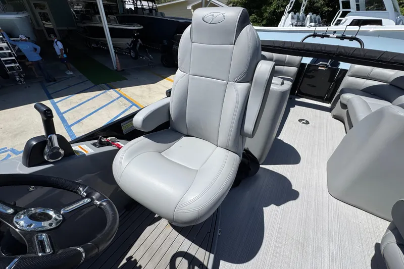 Slide: The Image of 2023 Veranda VTX 25RC boat interior with luxurious gray captain's chair and steering wheel. - 25