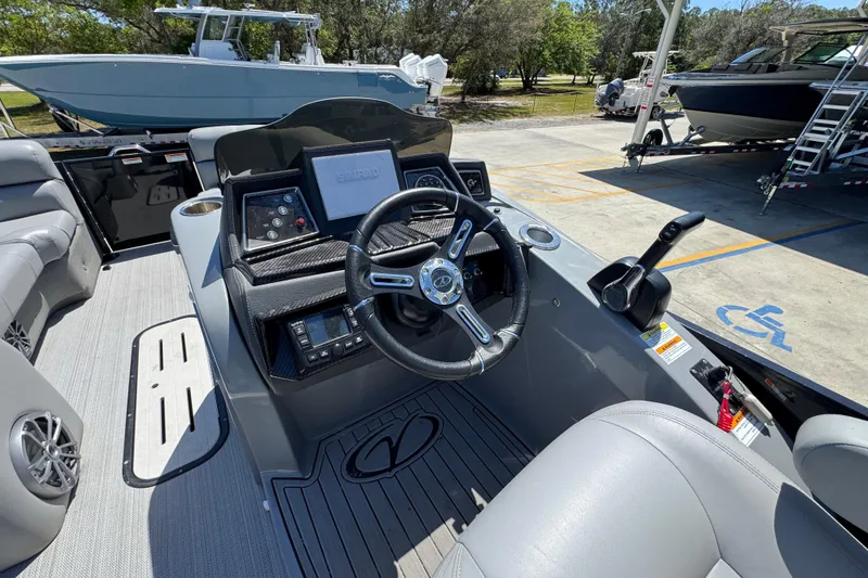 Slide: The Image of 2023 Veranda VTX 25RC boat cockpit with steering wheel, control panel, and seating. - 26