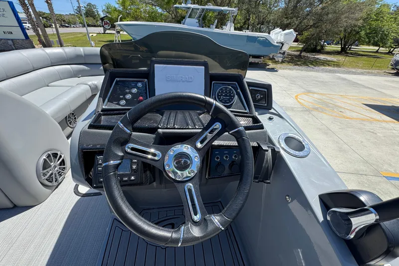 Slide: The Image of 2023 Veranda VTX 25RC boat dashboard with steering wheel and navigation controls. - 27