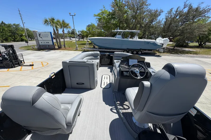 Slide: The Image of 2023 Veranda VTX 25RC pontoon boat interior with gray seating and modern dashboard. - 29