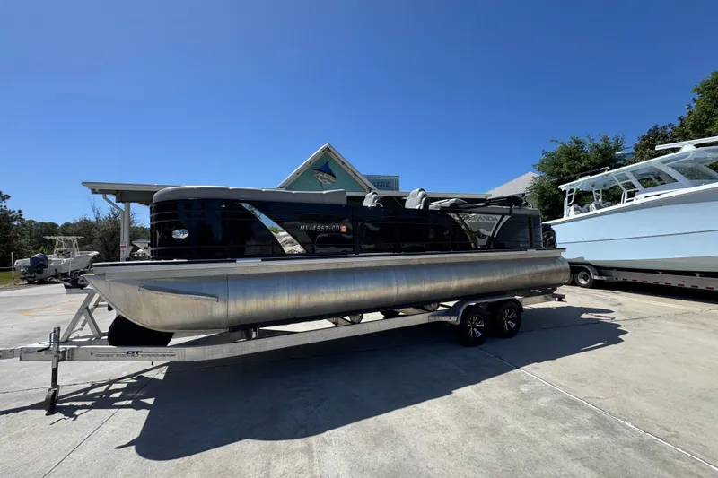 Slide: The Image of 2023 Veranda VTX 25RC pontoon boat on trailer under clear blue sky. - 3