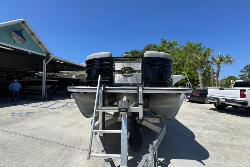 Slide: The Image of 2023 Veranda VTX 25RC pontoon boat on trailer under clear blue sky. - 6