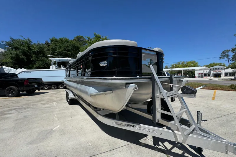 Slide: The Image of 2023 Veranda VTX 25RC pontoon boat on trailer in outdoor setting. - 7