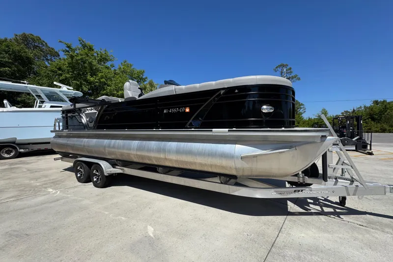 Slide: The Image of 2023 Veranda VTX 25RC pontoon boat on trailer, parked outdoors. - 8