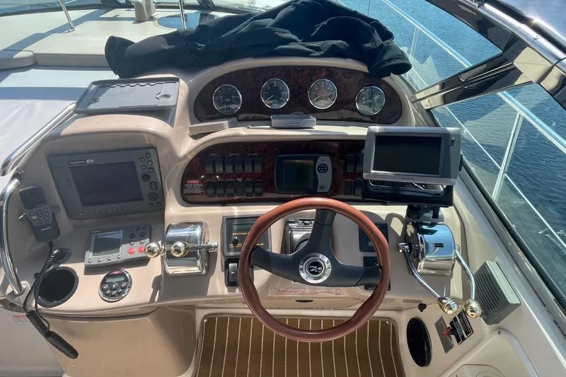 Slide: The Image of 2006 Sea Ray 360 Sundancer docked at marina, rear view with American flag. - 10