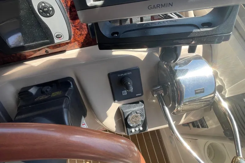 Slide: The Image of Helm of 2006 Sea Ray 360 Sundancer with navigation instruments and wooden steering wheel. - 12