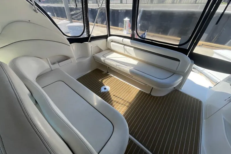 Slide: The Image of Interior of 2006 Sea Ray 360 Sundancer yacht with white seating and wood flooring. - 20