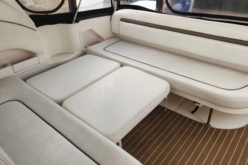 Slide: The Image of Interior of 2006 Sea Ray 360 Sundancer yacht with white seating and wood flooring. - 21