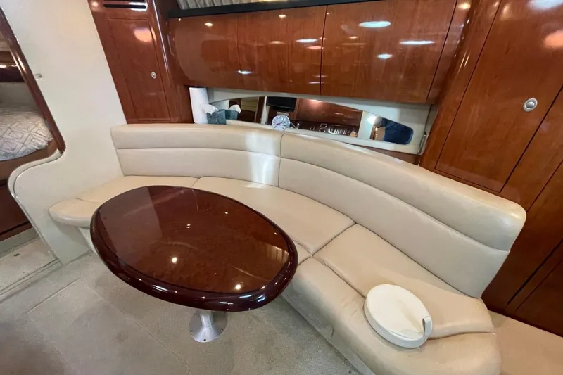 Slide: The Image of 2006 Sea Ray 360 Sundancer interior with white leather seating and striped flooring. - 24