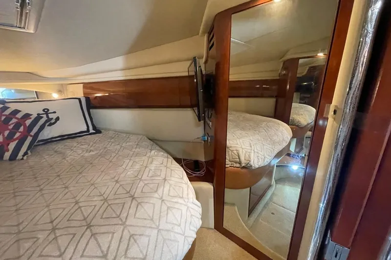Slide: The Image of Interior of 2006 Sea Ray 360 Sundancer with mounted TV and wooden paneling. - 32