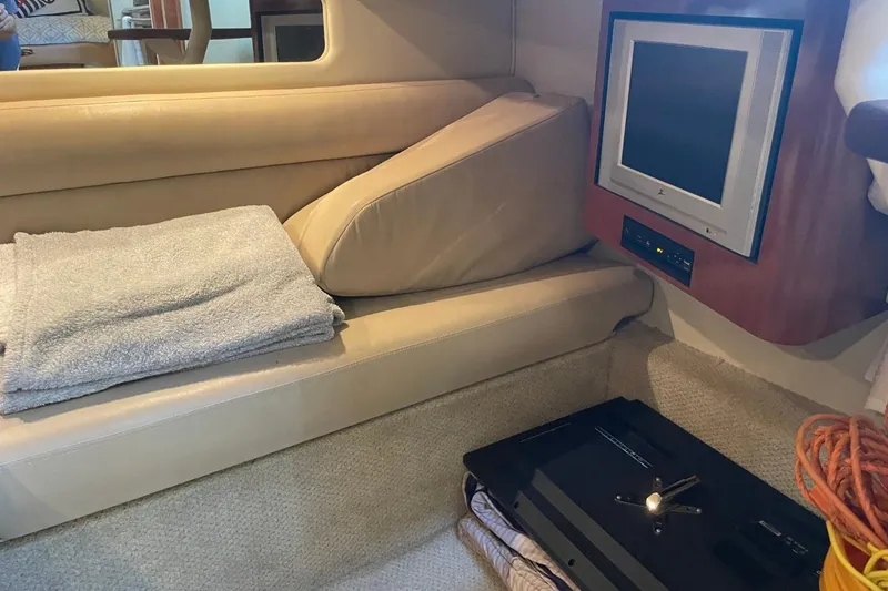 Slide: The Image of 2006 Sea Ray 360 Sundancer cabin with bed, nautical pillow, and mirrored closet. - 35