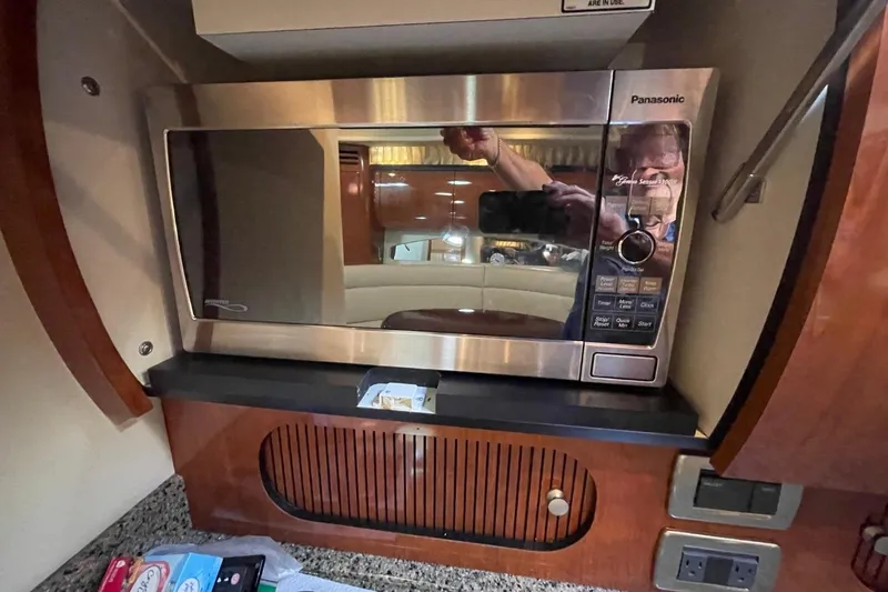 Slide: The Image of Open freezer compartment on 2006 Sea Ray 360 Sundancer yacht, showing interior storage space. - 44