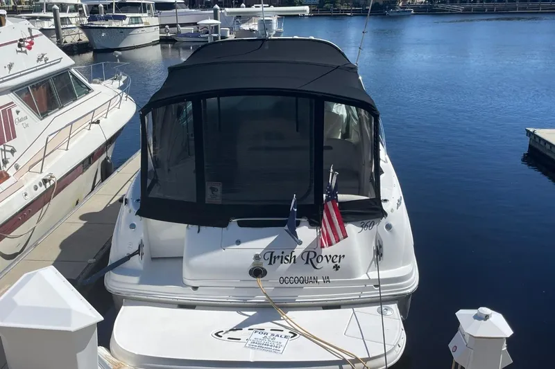 Slide: The Image of 2006 Sea Ray 360 Sundancer yacht docked in a marina under clear blue skies. - 5