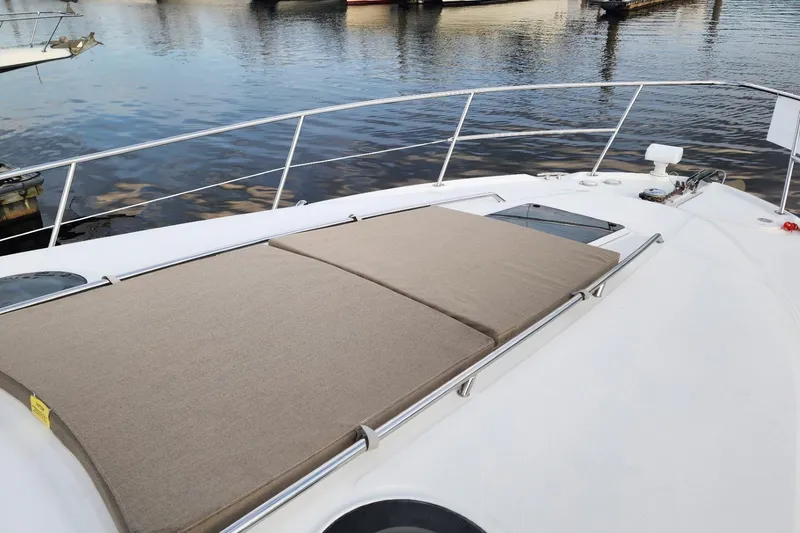 Slide: The Image of 2006 Sea Ray 360 Sundancer yacht with sunpad and hatch, docked near trees. - 51