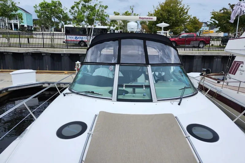 Slide: The Image of 2006 Sea Ray 360 Sundancer yacht docked at marina, featuring sunpad and sleek design. - 52