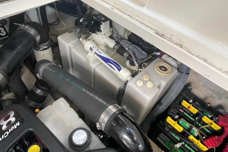 Slide: The Image of Engine compartment of a 2006 Sea Ray 360 Sundancer with visible components and batteries. - 67