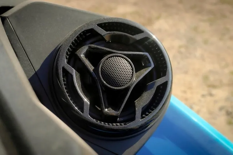 Slide: The Image of Close-up of 2026 Sea-Doo RXT-X 325 speaker detail on blue surface. - 10