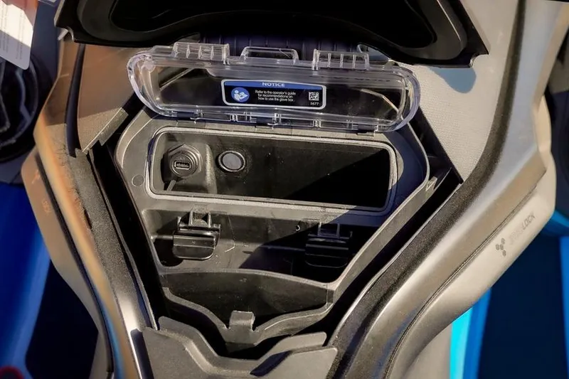 Slide: The Image of Storage compartment of 2026 Sea-Doo RXT-X 325 with USB port and protective cover. - 11