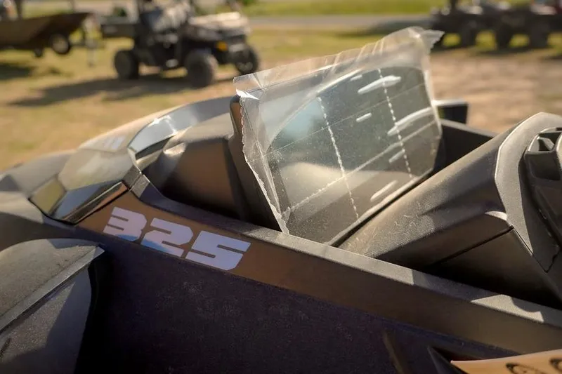 Slide: The Image of 2026 Sea-Doo RXT-X 325 close-up, showcasing sleek design and windshield detail. - 13