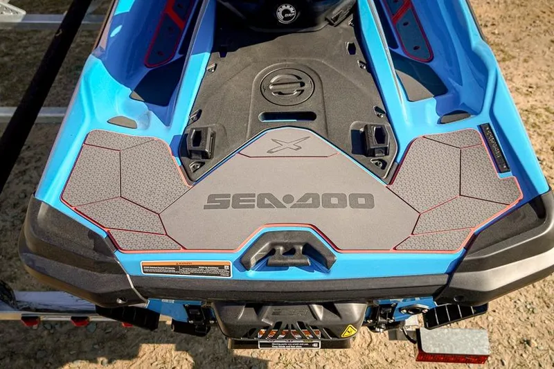 Slide: The Image of 2026 Sea-Doo RXT-X 325, blue and gray design, rear view on trailer. - 4