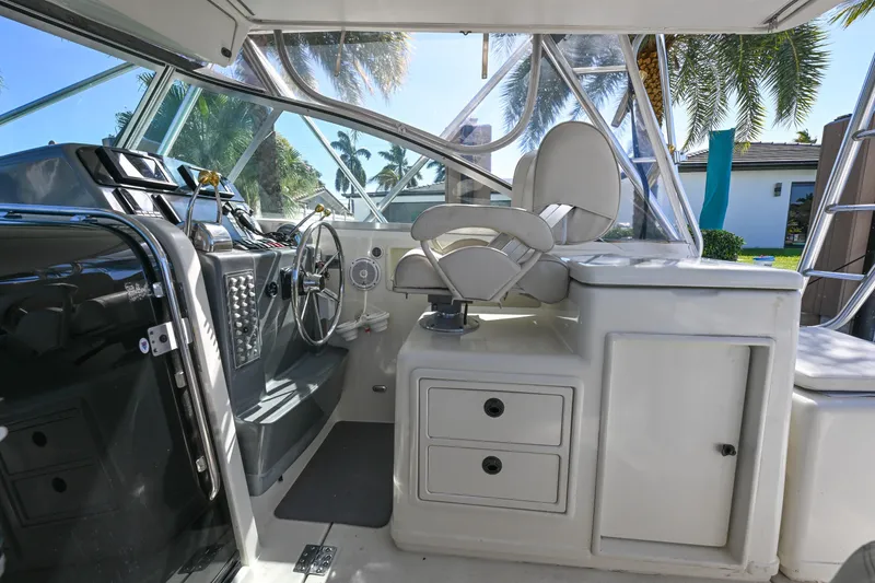 Slide: The Image of Cockpit of 2000 Pursuit 3400 Express boat with steering wheel and seating. - 32