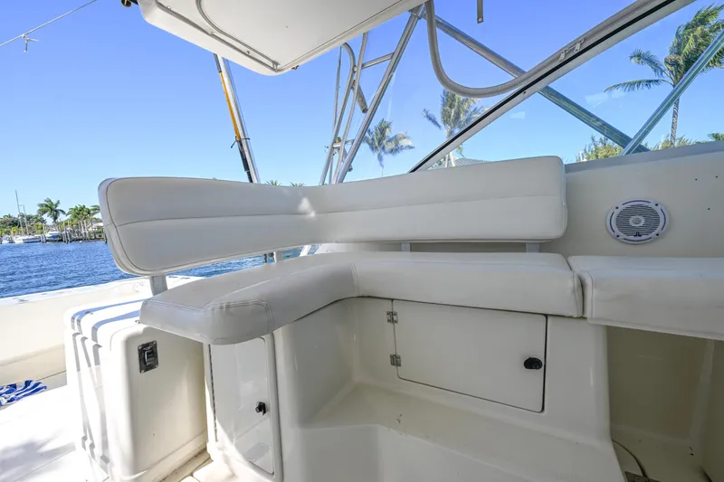 Slide: The Image of 2000 Pursuit 3400 Express boat interior with white seating and ocean view. - 39