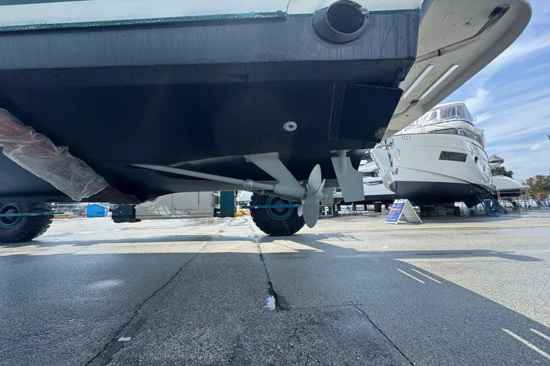 Slide: The Image of 2000 Pursuit 3400 Express boat on dry dock, showcasing propeller and hull. - 61