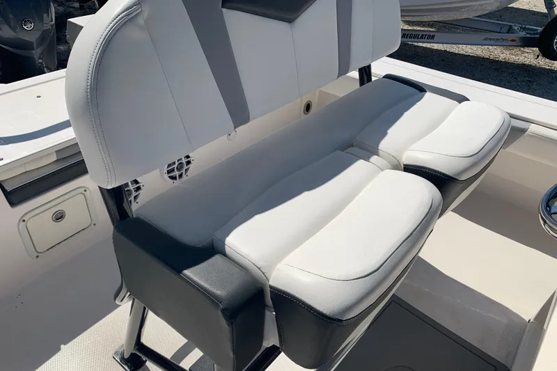 Slide: The Image of 2022 Robalo 246 Cayman boat seating with white and black cushioned design. - 15