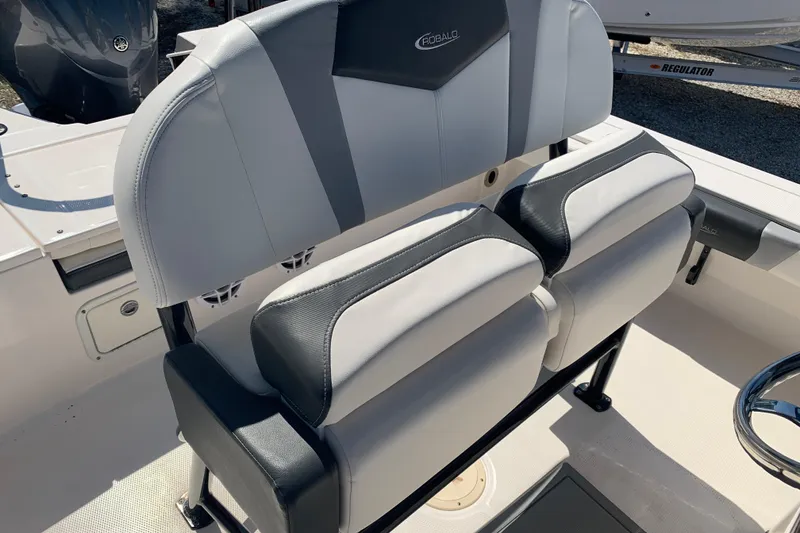 Slide: The Image of 2022 Robalo 246 Cayman boat seating with gray and black upholstery. - 16