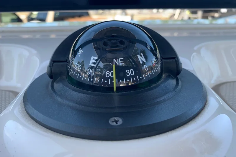 Slide: The Image of Compass on 2022 Robalo 246 Cayman boat dashboard, showing cardinal directions. - 17