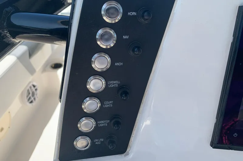 Slide: The Image of Control panel of 2022 Robalo 246 Cayman boat with labeled buttons and switches. - 20