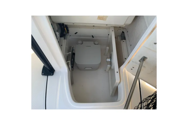 Slide: The Image of 2022 Robalo 246 Cayman boat storage compartment with equipment. - 25