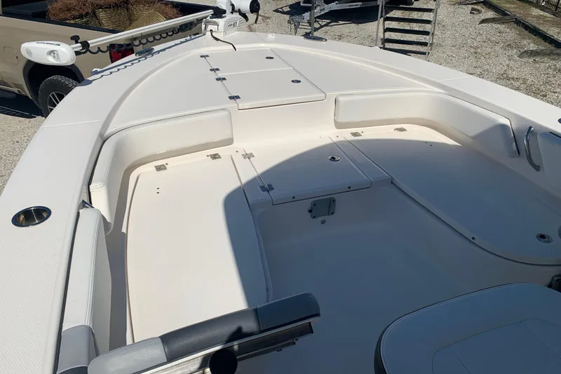 Slide: The Image of 2022 Robalo 246 Cayman boat deck with seating and storage compartments. - 26