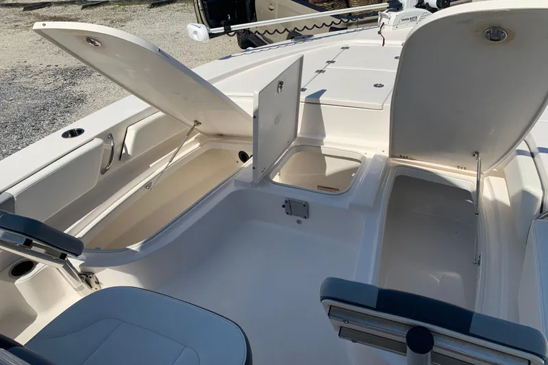 Slide: The Image of 2022 Robalo 246 Cayman boat interior with open storage compartments. - 28