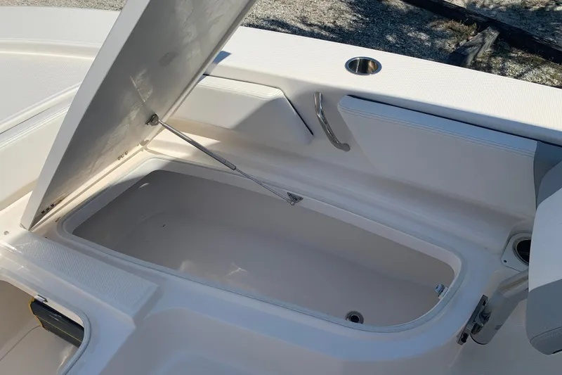 Slide: The Image of Open storage compartment on a 2022 Robalo 246 Cayman boat. - 30