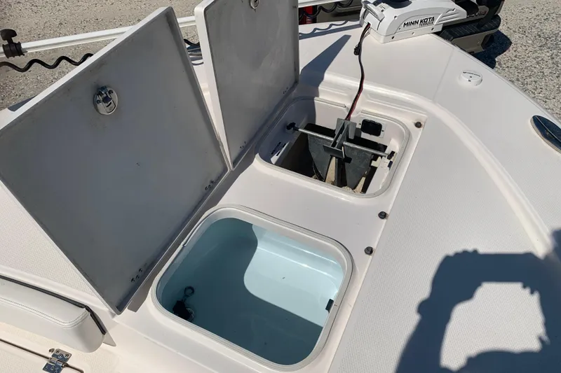 Slide: The Image of 2022 Robalo 246 Cayman boat storage compartments and anchor area, open for viewing. - 31