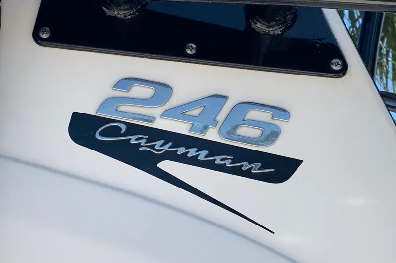 Slide: The Image of 2022 Robalo 246 Cayman boat logo on white surface. - 33