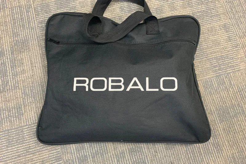 Slide: The Image of Black Robalo carrying bag on carpet, related to 2022 Robalo 246 Cayman model. - 34