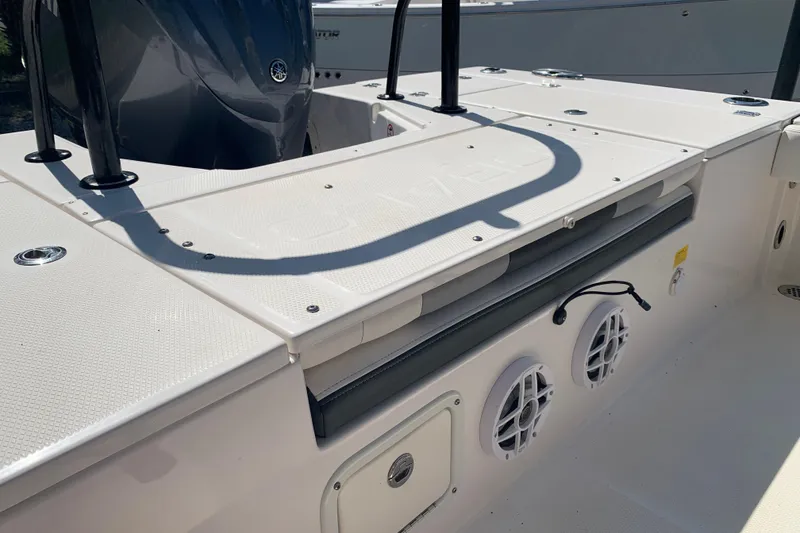 Slide: The Image of 2022 Robalo 246 Cayman boat deck with speakers and storage compartments. - 6