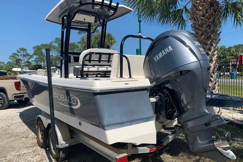 Slide: The Image of 2022 Robalo 246 Cayman boat with Yamaha engine on trailer, parked outdoors. - 7