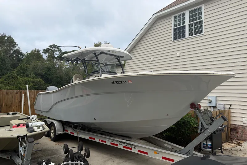 The Image of 2015 Sea Fox 286 Commander boat on trailer beside house. - 1