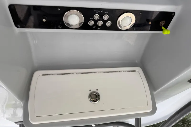 Slide: The Image of Control panel of a 2015 Sea Fox 286 Commander boat with switches and storage compartment. - 12