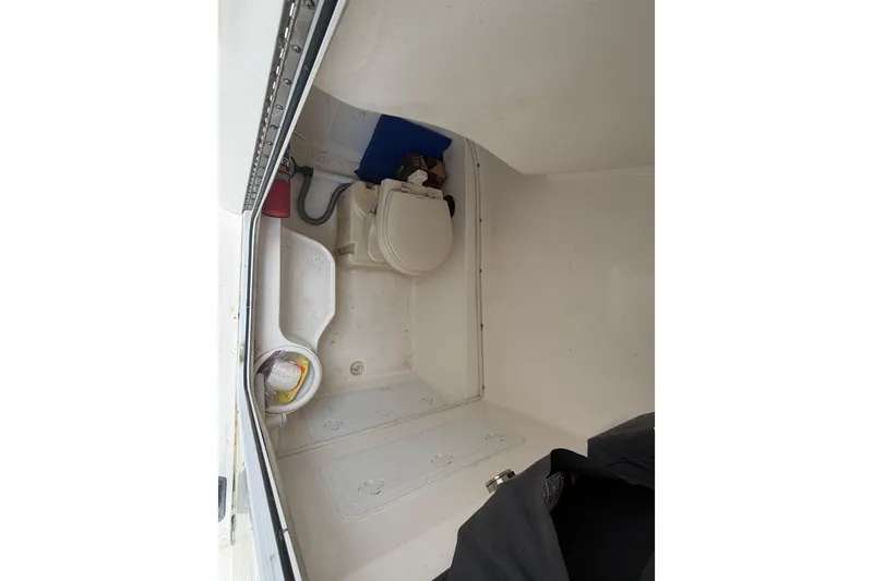 Slide: The Image of 2015 Sea Fox 286 Commander boat interior with toilet and storage area. - 13