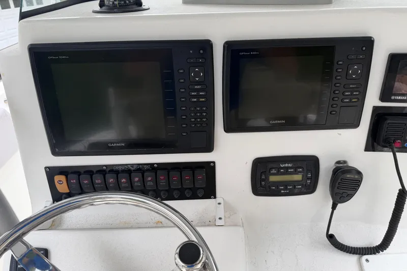 Slide: The Image of Control panel of 2015 Sea Fox 286 Commander with Garmin displays and marine radio. - 15