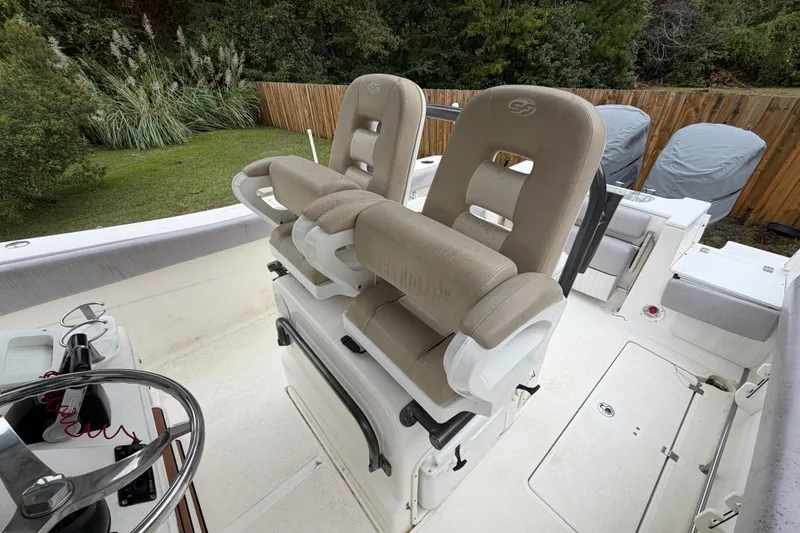 Slide: The Image of 2015 Sea Fox 286 Commander boat interior with dual helm seats and steering wheel. - 18