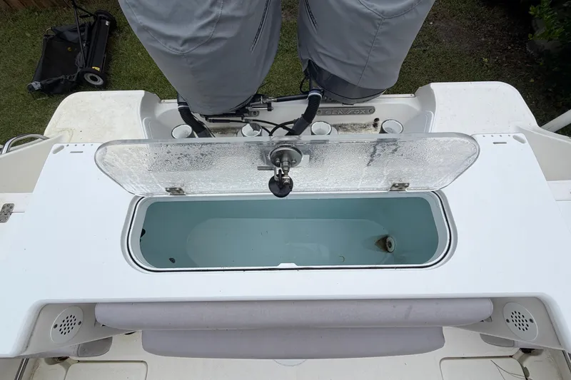 Slide: The Image of 2015 Sea Fox 286 Commander livewell with open lid, showcasing interior and motor. - 24